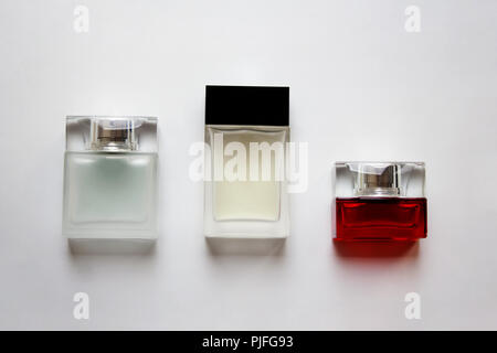 Three rectangular glass perfume bottles isolated on white background Stock Photo