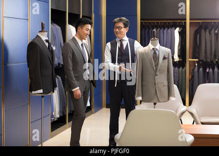 Fashion designer showing customer business suit Stock Photo