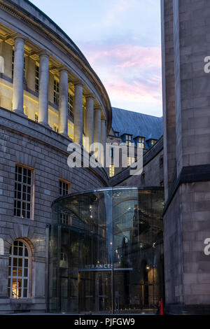 Manchester, ENgland, UK - July 1, 2018: The sun sets behind the modern entrance to Manchester's classical Central Library and Town Hall Extension buil Stock Photo