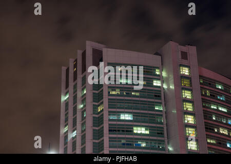 London, England, UK - February 27, 2018: The modern tower building of University College London Hospital (UCH) stands against the night sky in the Bl Stock Photo