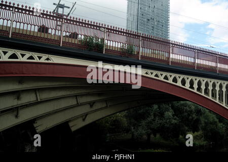 View of a cast iron railway bridge at Castlefields, Manchester, England. The sweeping arches of the Victorian structure provide elegance and beauty. Stock Photo