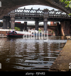 Manchester, England, UK - May 21, 2011: An East Midlands Trains passenger train crosses Castlefield basin on the Bridgewater Canal in Manchester. Stock Photo