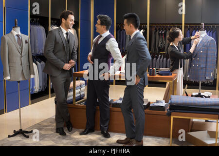 Confident fashion designer and businessmen talking Stock Photo
