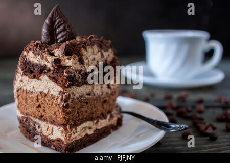 Tasty piece of chocolate cake on wooden table background Stock Photo
