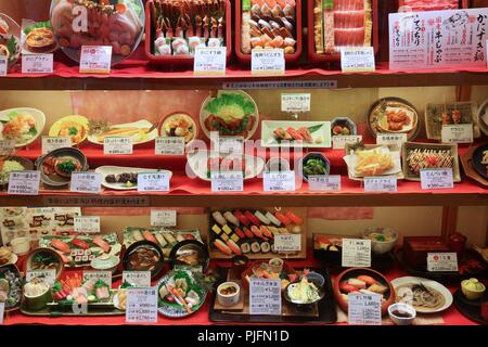 OSAKA, JAPAN - NOVEMBER 22, 2016: Japanese restaurant with plastic food display in Osaka, Japan. Artificial food displays in restaurant windows are an Stock Photo