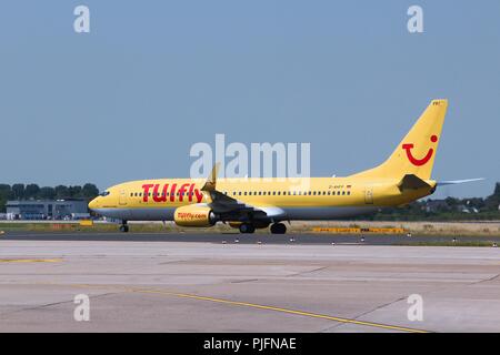 DUSSELDORF, GERMANY - JULY 8, 2013: TUIfly Boeing 737 lands at Dusseldorf Airport, Germany. TUIfly is part of TUI Travel,  an international leisure tr Stock Photo