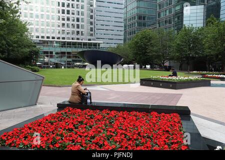 LONDON, UK - JULY 8, 2016: People visit Canary Wharf modern area in London, UK. Canary Wharf is London's second financial centre. Stock Photo