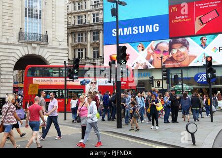 LONDON, UK - JULY 9, 2016: People visit Piccadilly Circus in London. London is the most populous city in the UK with 13 million people living in its m Stock Photo