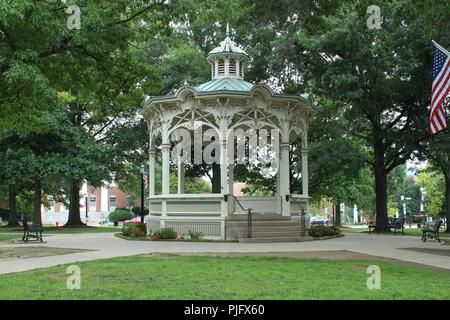 white gazebo in a park in a rural town square Stock Photo