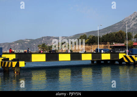 Peloponnese Greece People on Motorbikes Crossing Entrance to Corinth Canal Stock Photo