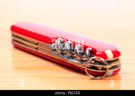 Swiss knife on a wooden background Stock Photo