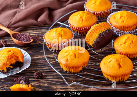 freshly baked sweet pumpkin muffins on a rustic wooden table, close-up Stock Photo
