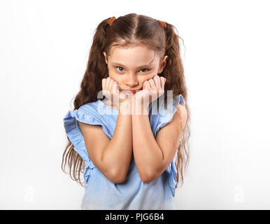 Beautiful thinking girl looking sad with hands under the face. Closeup portarit of cute kid with long hair on white background Stock Photo