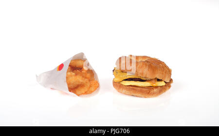 Burger King breakfast with a sausage egg and cheese croissan’wich or croissant and hash browns Stock Photo