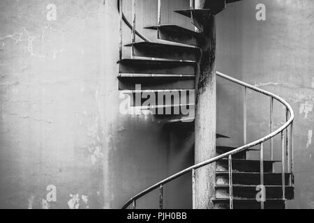 Rustic curved spiral staircase with railing close-up Stock Photo