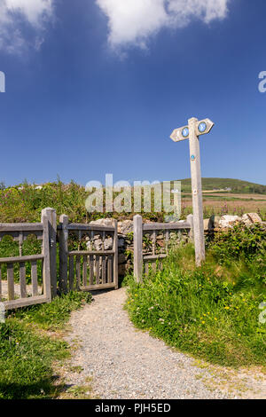 Anglesey coastal path gate and signpost at Church Bay, Anglesey, North Wales on a sunny summer's day Stock Photo