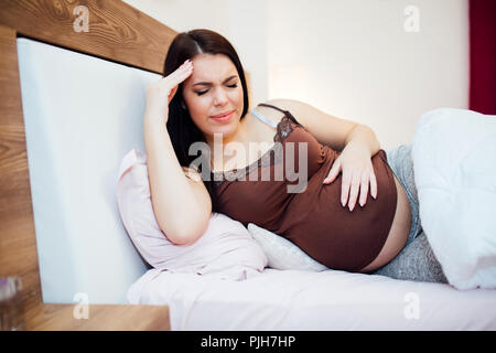 Beautiful pregnant woman struggling with headache