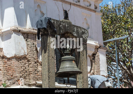 Small bell on wooden square pillars in Buddhist temple, Nepal. Stock Photo