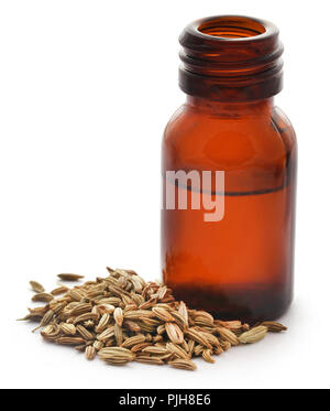 Fennel seeds with essential oil in a bottle over white background Stock Photo