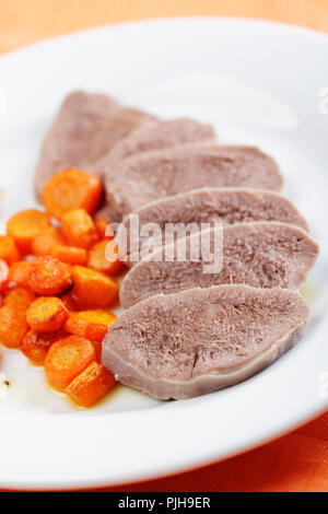 Boiled beef tongue with roasted carrot Stock Photo