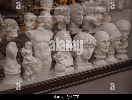 A couple of statues on a window in the center of Tallinn, Estonia. Stock Photo