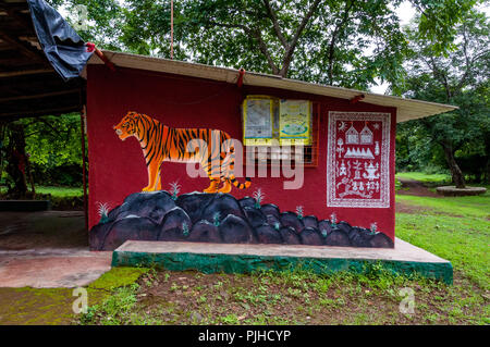 MUMBAI, INDIA – August 9 2018: Mural of a tiger on a Warli temple surrounded by trees. Warli are indigenous tribal people known for their art. They re Stock Photo