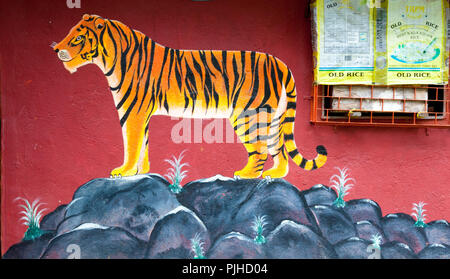 MUMBAI, INDIA – August 9 2018: Tiger painted on the wall of a Warli temple.  Warli are indigenous tribal people. In Mumbai at SGNP they live alongside Stock Photo