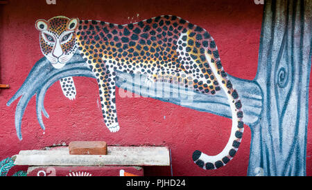 MUMBAI, INDIA – August 9 2018: Leopard painted on the wall of a Warli big-cat temple. Warli are indigenous tribal people. Stock Photo