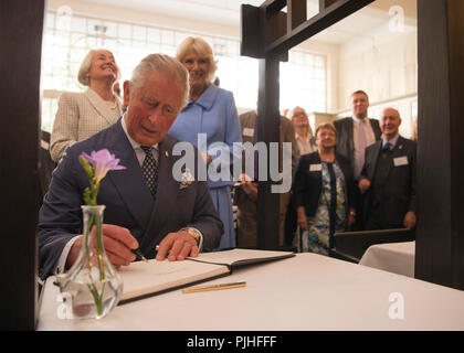 The Prince of Wales known as the Duke of Rothesay while in Scotland, signs the visitor book at the Mackintosh at the Willow tea rooms Glasgow. Stock Photo