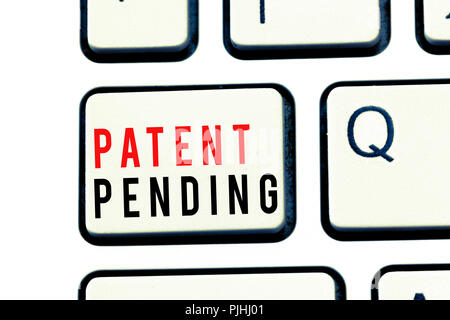 Writing note showing Patent Pending. Business photo showcasing Request already filed but not yet granted Pursuing protection. Stock Photo