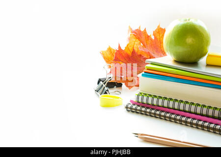 Colorful school supplies, book, apple on white. Close up. Back to school. Stock Photo