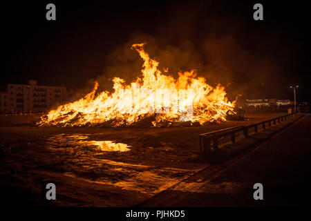The swirling orange coloured flames of a large bonfire at night Stock ...