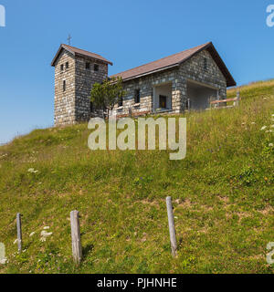 A chapel on the summit of Mt. Rigi in Switzerland in summer. The Rigi is a popular tourist destination, accessible by a mountain rack railway. Stock Photo