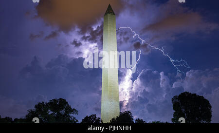 Lightning strikes over the Washington Monument in Washington, D.C., lighting up the storms clouds as thunderstorms passed through. Stock Photo