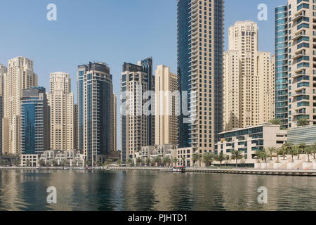Skyscrapers in Dubai Marina, with the sand-coloured residential towers of Jumeirah Beach Residence in the background, in Dubai, United Arab Emirates.  Stock Photo