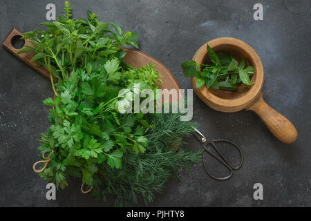 Fresh bundle of fresh herbs. Basil, mint, oregano on dark. Kitchen herbs. Stock Photo