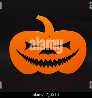 Halloween background decor holiday concept. orange pumpkin funny face shadow and silhouette on black background Stock Photo