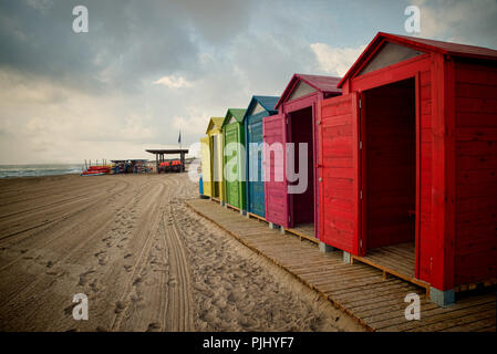 Multicolored beach huts on a sandy Mediterranean beach Stock Photo