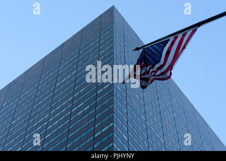 11-2017 New York, USA.  The American flag flying in front of a commercial office building in Manhattan. Photo: © Simon Grosset Stock Photo