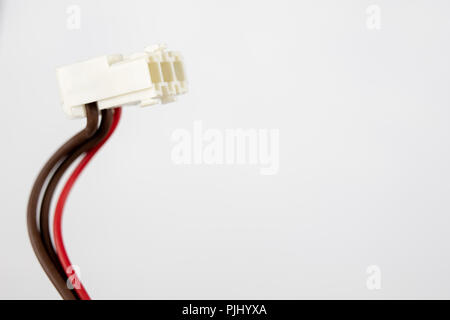 Old cables for electrical devices on a white table. Electrical connectors from household appliances. White background. Stock Photo