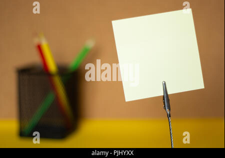 Stickers and colored pencils on a blurry cork board background, copy space Stock Photo