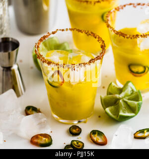 cocktail margarita of tequila, mango juice, hot pepper and lime on the table. bar accessories Stock Photo
