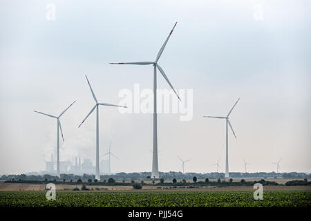 Street towards windmills with cloudy weather. Stock Photo