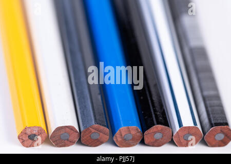 Several unsharpened new graphite pencils of different colors and patterns Stock Photo