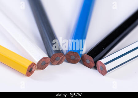 Several unsharpened new graphite pencils of different colors and patterns Stock Photo