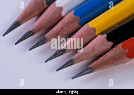 Several sharp new lead graphite pencils of various colors and patterns Stock Photo