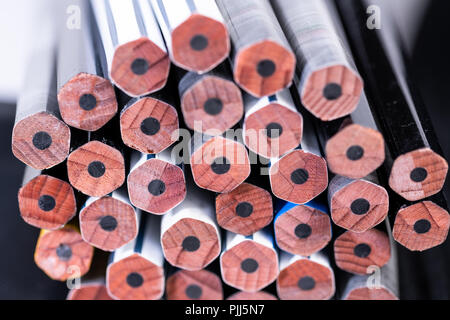 Several unsharpened new graphite pencils of different colors and patterns Stock Photo