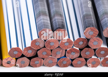 Several unsharpened new graphite pencils of different colors and patterns Stock Photo