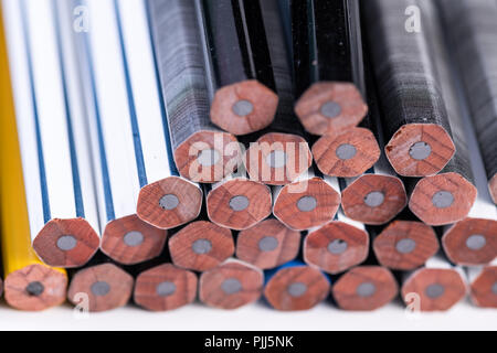 Several unsharpened new graphite pencils of different colors and patterns Stock Photo