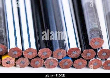 Several unsharpened new graphite pencils of different colors and patterns Stock Photo